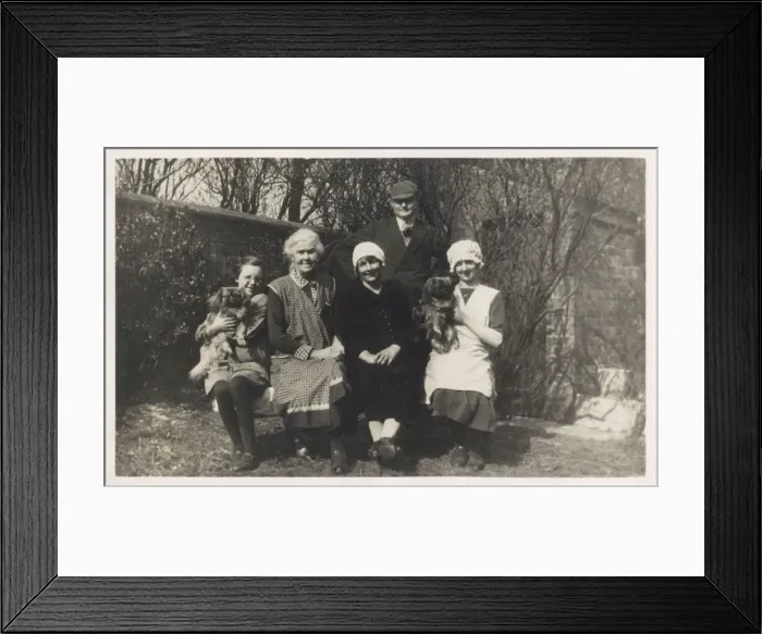 Framed Print : Family group with two dogs in a garden Framed Print : Family group with two dogs in a garden
