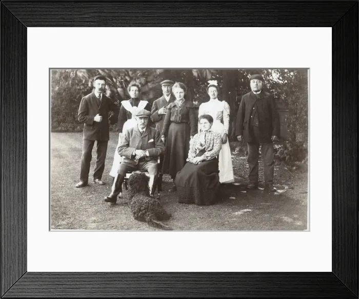 Framed Print : Family group with black poodle in a garden Framed Print : Family group with black poodle in a garden