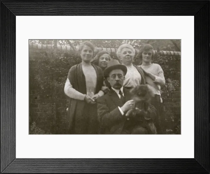 Framed Print : Family group with dog in a garden