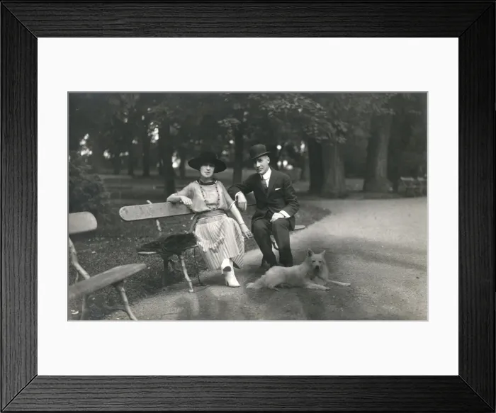 Framed Print : Couple in a park with a dog, France Framed Print : Couple in a park with a dog, France