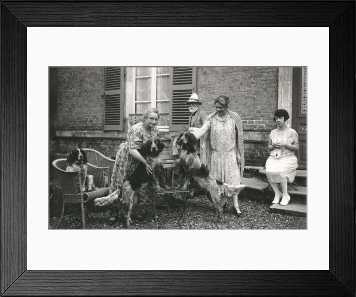 Framed Print : People with three dogs in a garden, France Framed Print : People with three dogs in a garden, France
