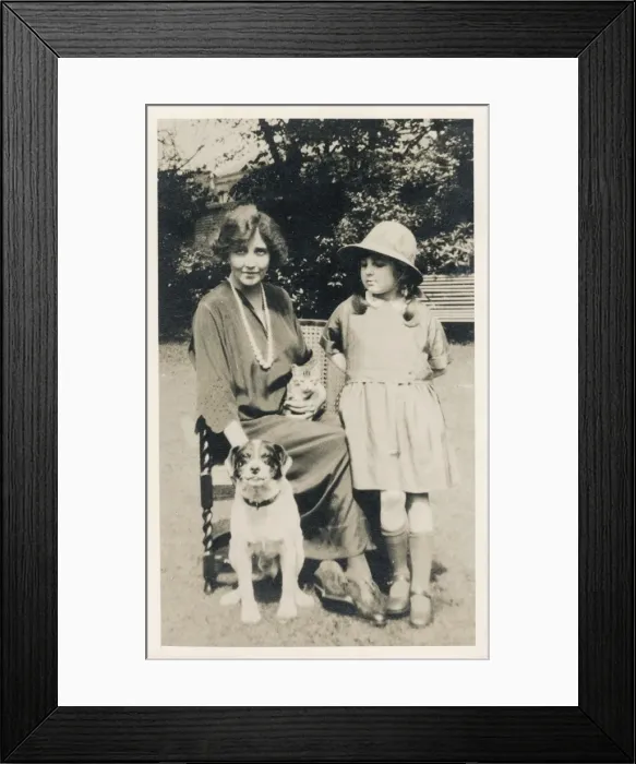 Framed Print : Woman and girl with dog and cat in a garden Framed Print : Woman and girl with dog and cat in a garden