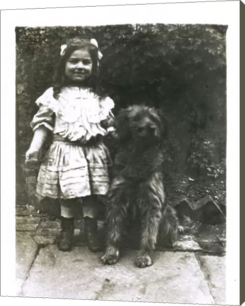Little girl with a dog in a garden