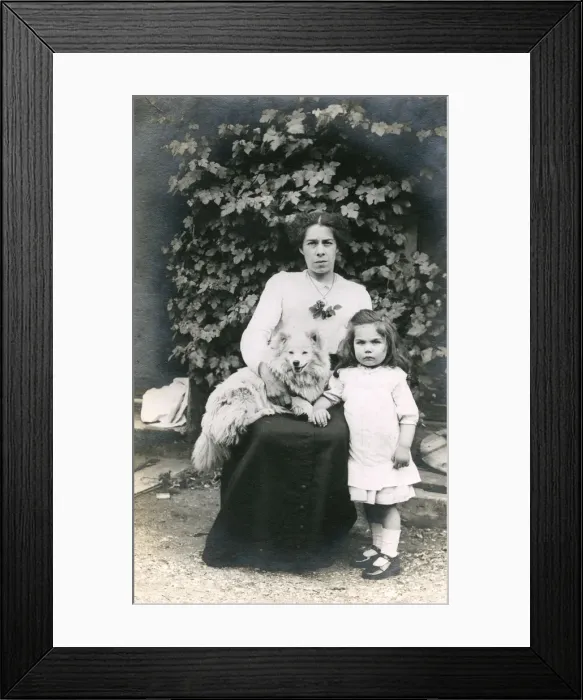 Framed Print : Woman and girl with dog in a garden Framed Print : Woman and girl with dog in a garden