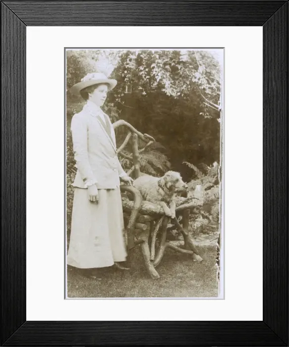 Framed Print : Woman with a dog in a garden Framed Print : Woman with a dog in a garden