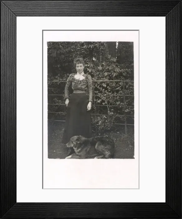 Framed Print : Woman with a dog in a garden Framed Print : Woman with a dog in a garden