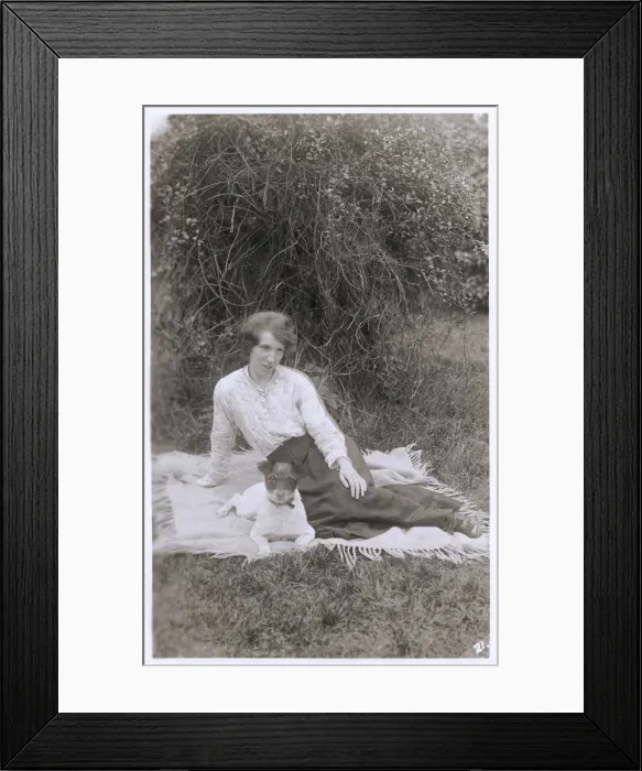 Framed Print : Young woman with a dog in a garden Framed Print : Young woman with a dog in a garden