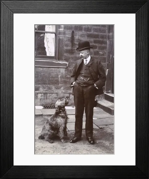 Framed Print : Man with terrier dog outside a building Framed Print : Man with terrier dog outside a building