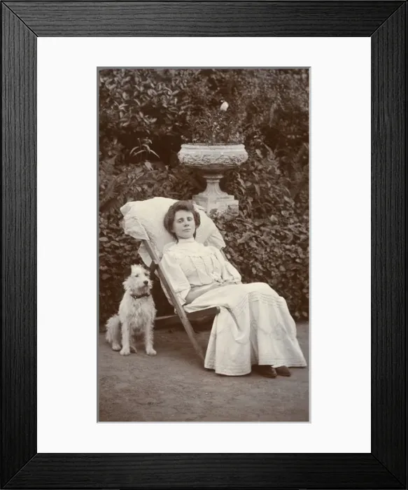 Framed Print : Young woman and dog in a garden Framed Print : Young woman and dog in a garden