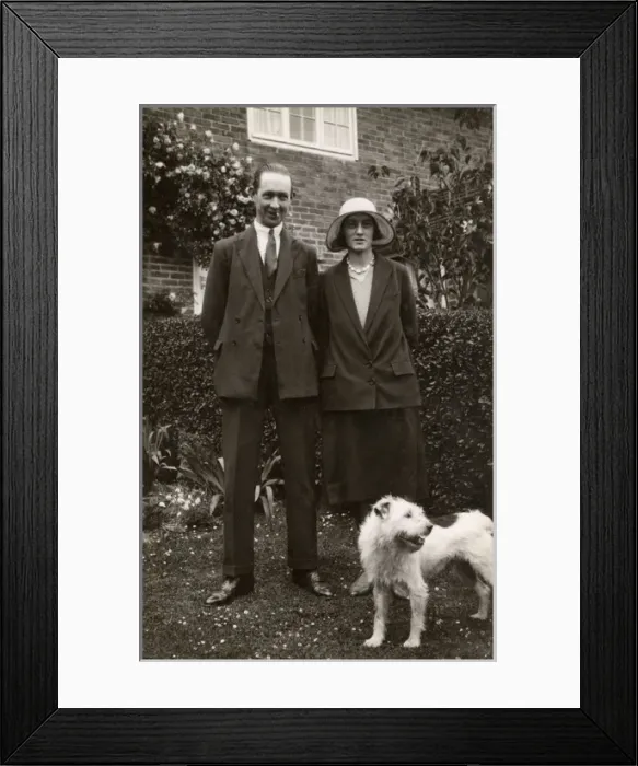 Framed Print : Man and woman with a terrier dog in a garden Framed Print : Man and woman with a terrier dog in a garden