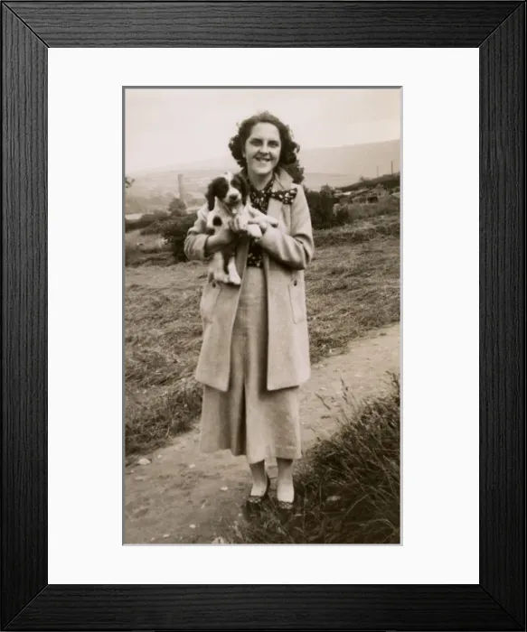 Framed Print : Woman and puppy on a hillside Framed Print : Woman and puppy on a hillside
