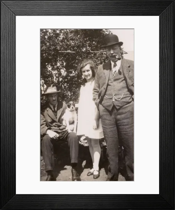 Framed Print : Three people and a dog in a garden Framed Print : Three people and a dog in a garden