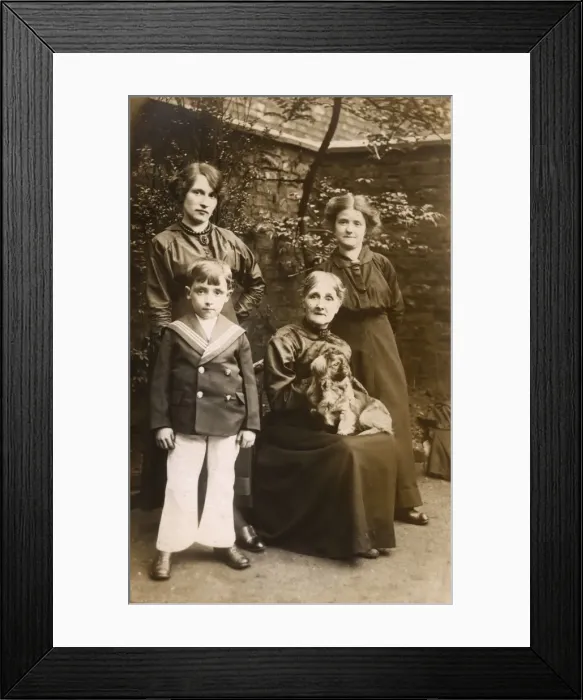 Framed Print : Family of four with a dog in a garden Framed Print : Family of four with a dog in a garden