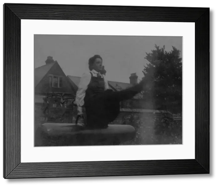 Framed Print : Student on vaulting horse in garden Framed Print : Student on vaulting horse in garden