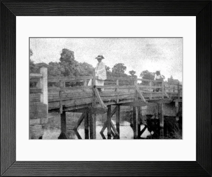 Framed Print : Woman seated on bridge Framed Print : Woman seated on bridge