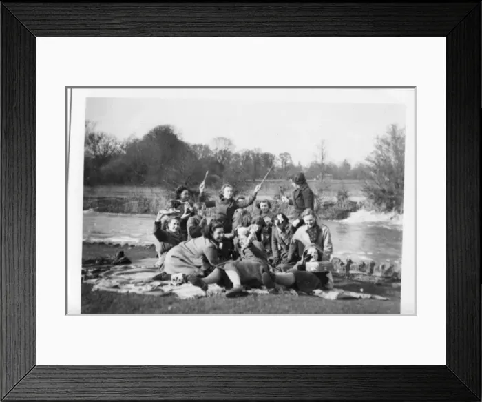 Framed Print : Picnic group in coats on rugs