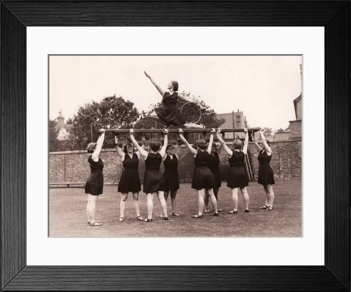 Framed Print : Eight girls hold aloft ninth on gym bench posing with hoop Framed Print : Eight girls hold aloft ninth on gym bench posing with hoop