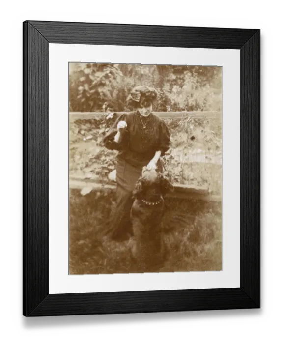 Framed Print : Woman with a dog in a garden Framed Print : Woman with a dog in a garden