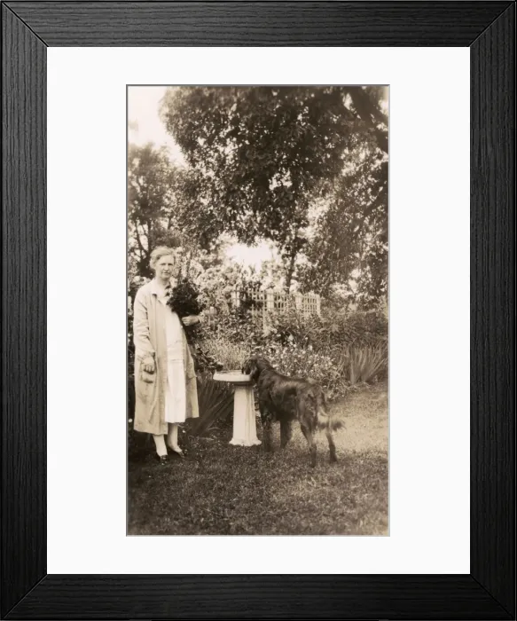 Framed Print : Woman with a dog in a garden Framed Print : Woman with a dog in a garden