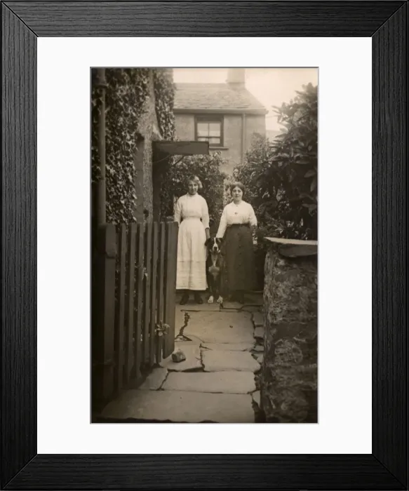 Framed Print : Two women with a dog outside a house Framed Print : Two women with a dog outside a house