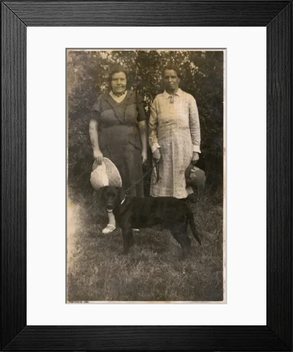 Framed Print : Two women with a dog in a garden Framed Print : Two women with a dog in a garden