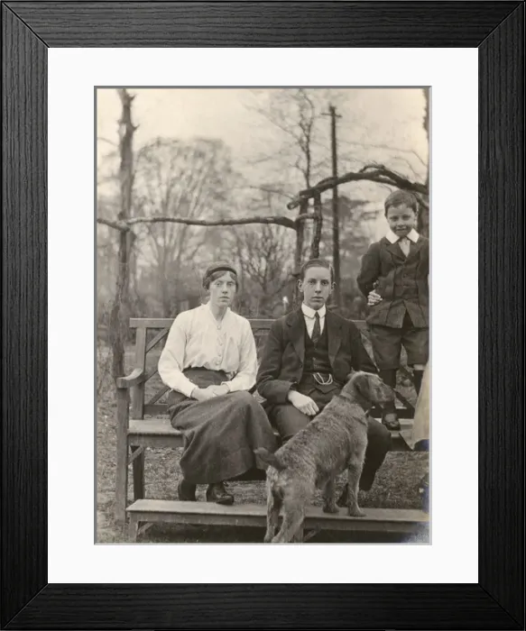 Framed Print : Family group with a dog in a garden Framed Print : Family group with a dog in a garden