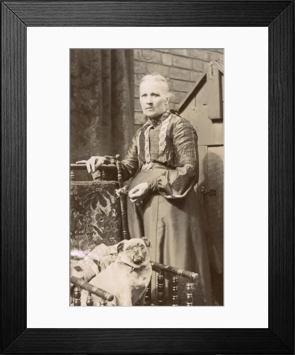 Framed Print : Woman with a dog in a back garden Framed Print : Woman with a dog in a back garden
