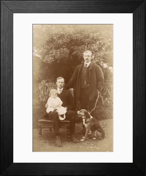 Framed Print : Two men, a little girl and a dog in a garden Framed Print : Two men, a little girl and a dog in a garden