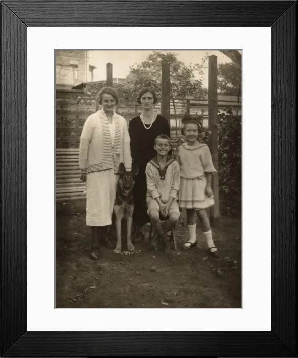 Framed Print : Four people with a German Shepherd dog in a garden Framed Print : Four people with a German Shepherd dog in a garden