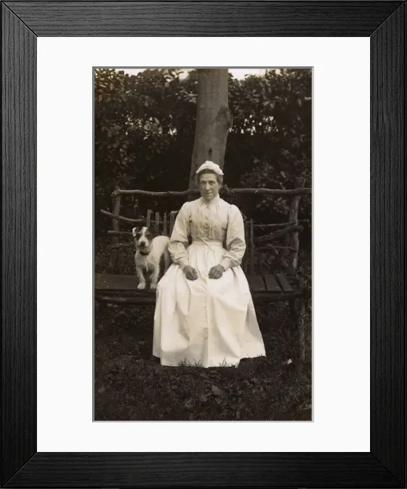 Framed Print : Woman with terrier on a bench in a garden Framed Print : Woman with terrier on a bench in a garden
