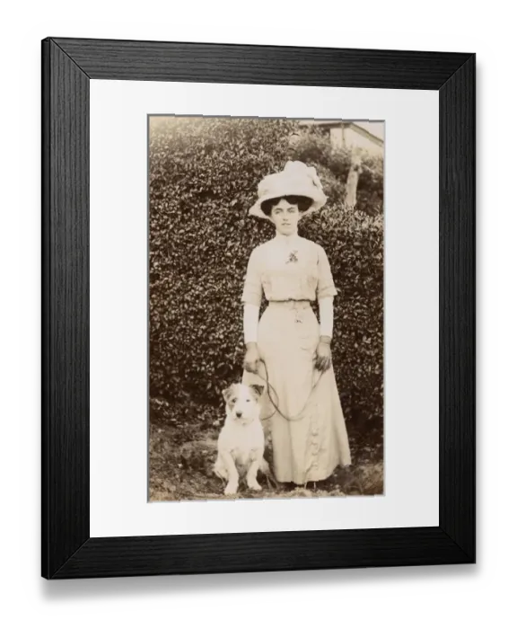 Framed Print : Edwardian woman with a terrier in a garden Framed Print : Edwardian woman with a terrier in a garden