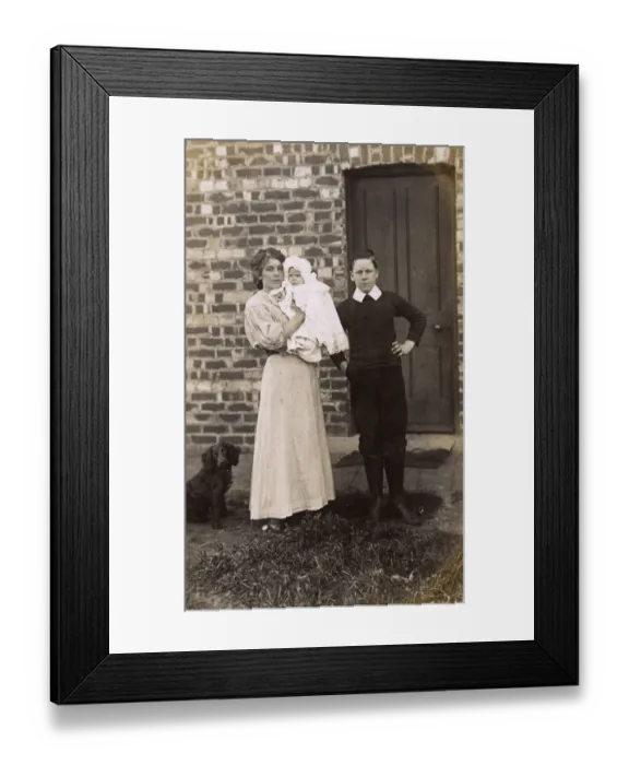 Framed Print : Girl and boy with baby and spaniel outside a house Framed Print : Girl and boy with baby and spaniel outside a house