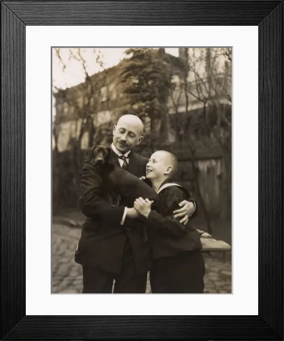 Framed Print : Man and boy holding a dachshund Framed Print : Man and boy holding a dachshund