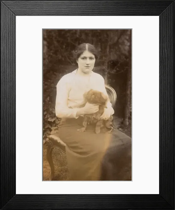 Framed Print : Young woman with Pekingese dog in a garden Framed Print : Young woman with Pekingese dog in a garden