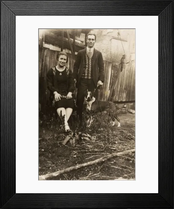 Framed Print : Couple with a dog in a garden Framed Print : Couple with a dog in a garden