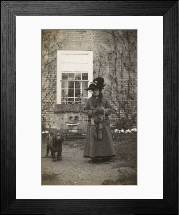 Framed Print : Woman with spaniel dog outside a house Framed Print : Woman with spaniel dog outside a house