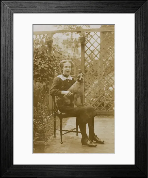 Framed Print : Girl with a dog in a garden Framed Print : Girl with a dog in a garden