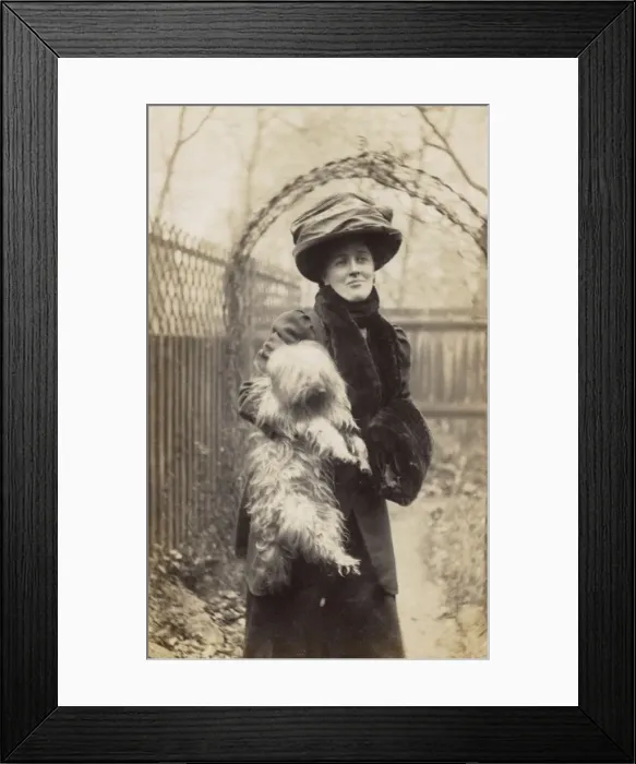 Framed Print : Edwardian woman holding a terrier in a garden Framed Print : Edwardian woman holding a terrier in a garden