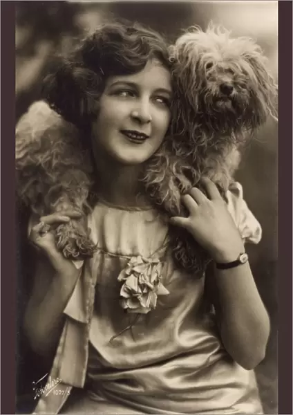 Studio portrait, young woman with terrier dog