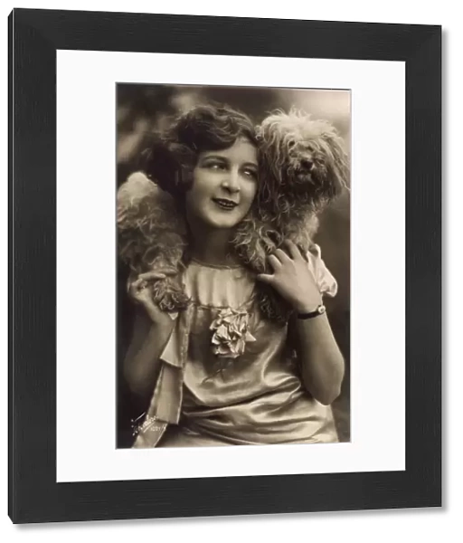 Studio portrait, young woman with terrier dog