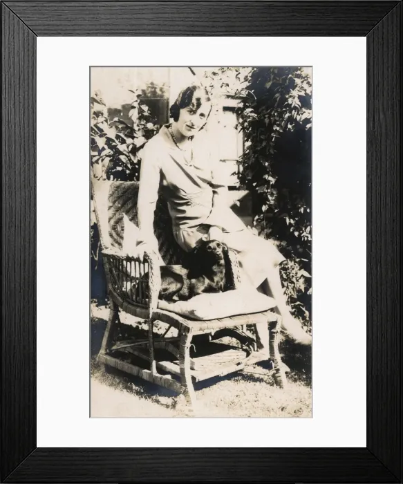 Framed Print : Woman with a dog in a garden Framed Print : Woman with a dog in a garden