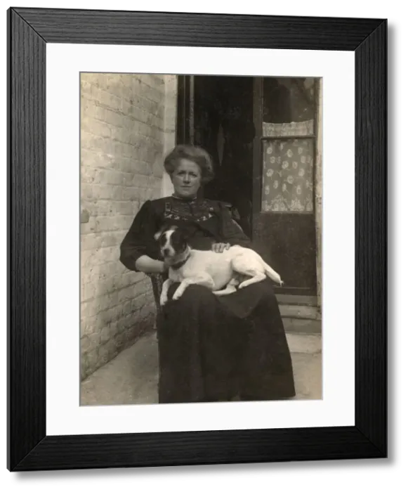 Framed Print : Woman with a Jack Russell terrier outside a house Framed Print : Woman with a Jack Russell terrier outside a house