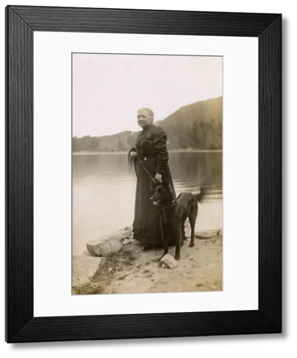Framed Print : Woman with a dog by a lake, Vosges, France Framed Print : Woman with a dog by a lake, Vosges, France