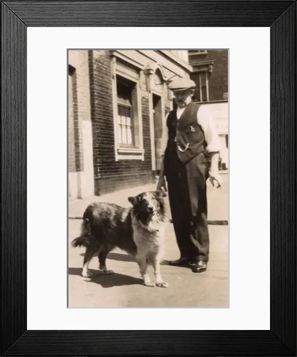Framed Print : Man with a collie dog in a street Framed Print : Man with a collie dog in a street