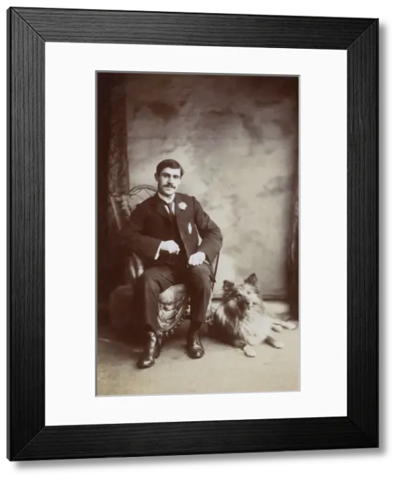 Framed Print : Studio portrait, young man with his dog Framed Print : Studio portrait, young man with his dog