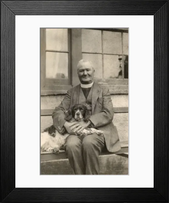 Framed Print : Vicar with a spaniel dog on a bench Framed Print : Vicar with a spaniel dog on a bench