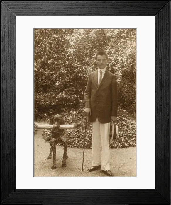 Framed Print : Young man with a dog in a garden Framed Print : Young man with a dog in a garden