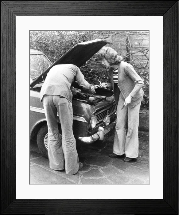 Framed Print : Couple trying to fix a car on a London street Framed Print : Couple trying to fix a car on a London street