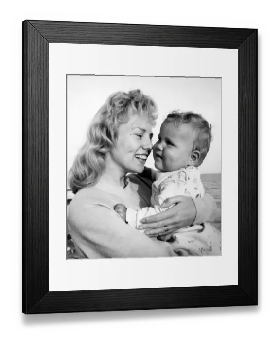 Framed Print : Woman at seaside holding a baby Framed Print : Woman at seaside holding a baby