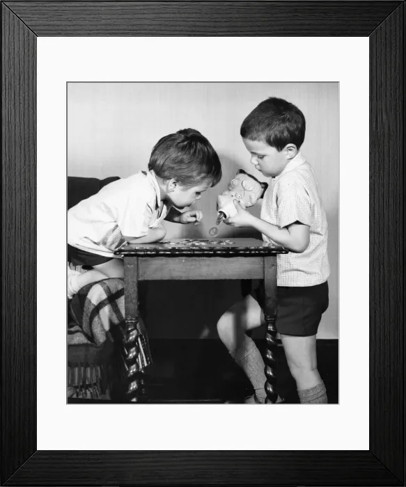 Framed Print : Two boys emptying a piggy bank Framed Print : Two boys emptying a piggy bank